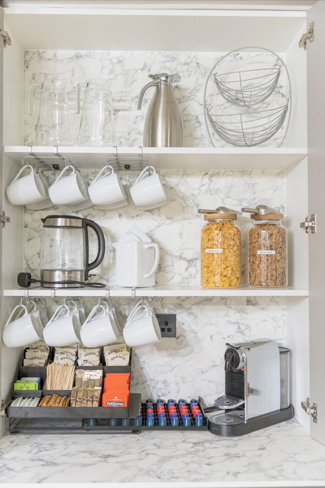 Coffee station with Nespresso machine, mugs and teas