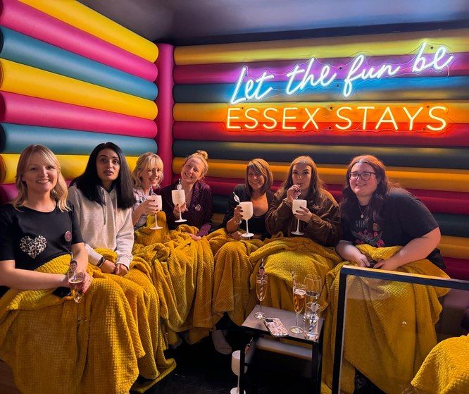 Group of friends in robes and blankets in the karaoke room