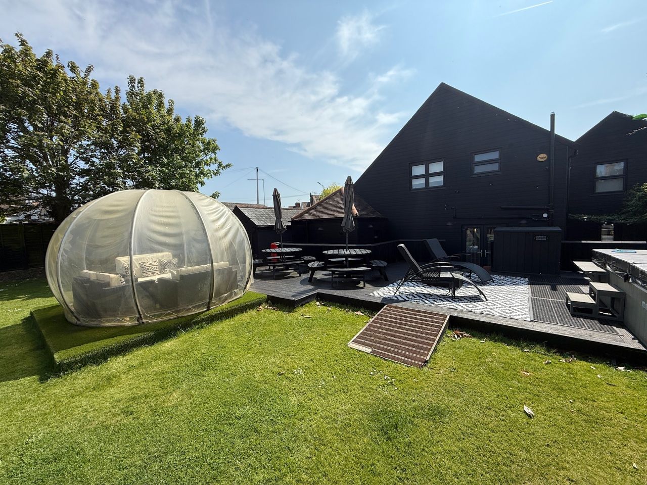 Garden igloo beside the decking, picnic tables and loungers