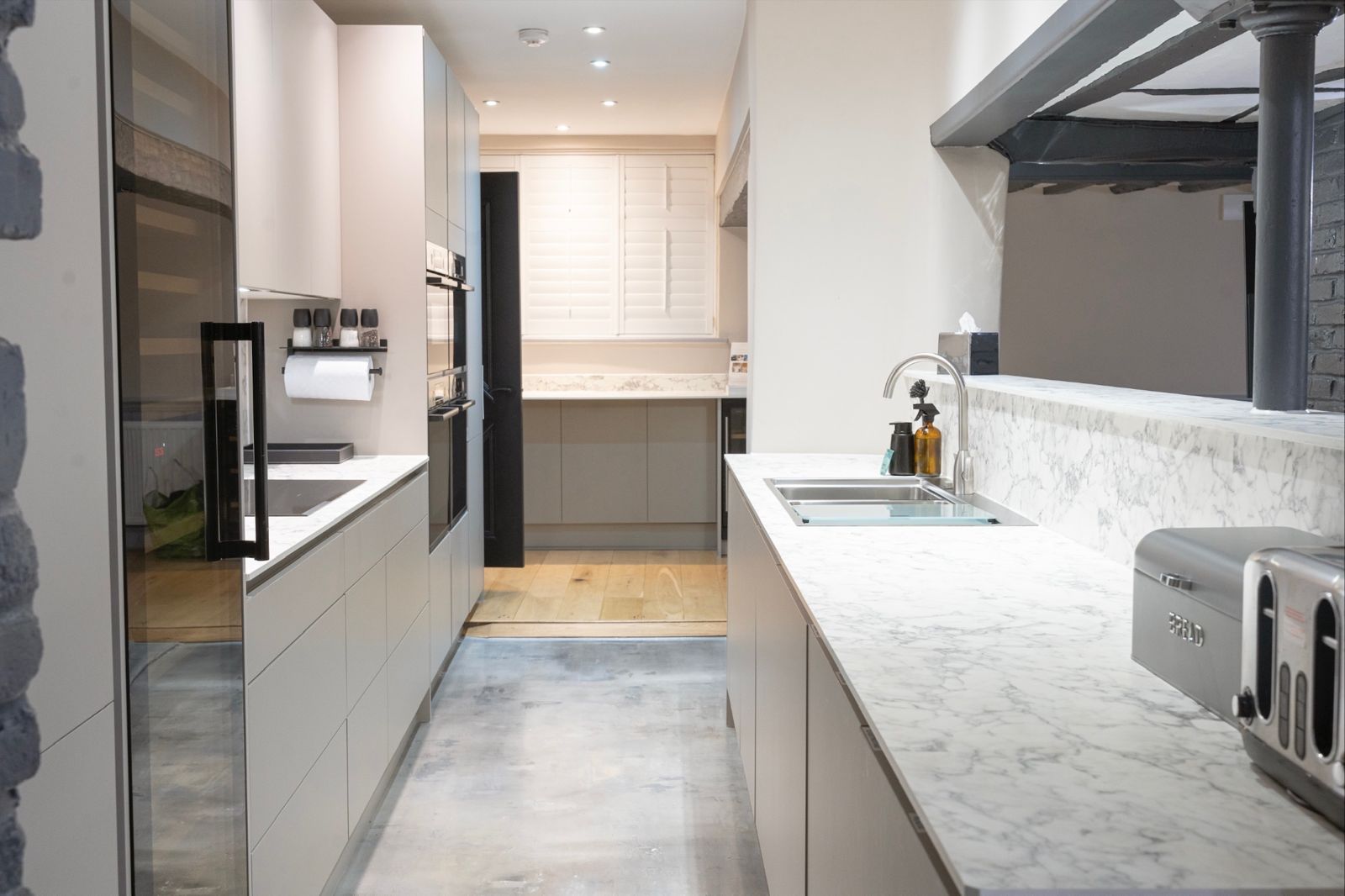 Galley kitchen with four Bosch ovens and marble worktops