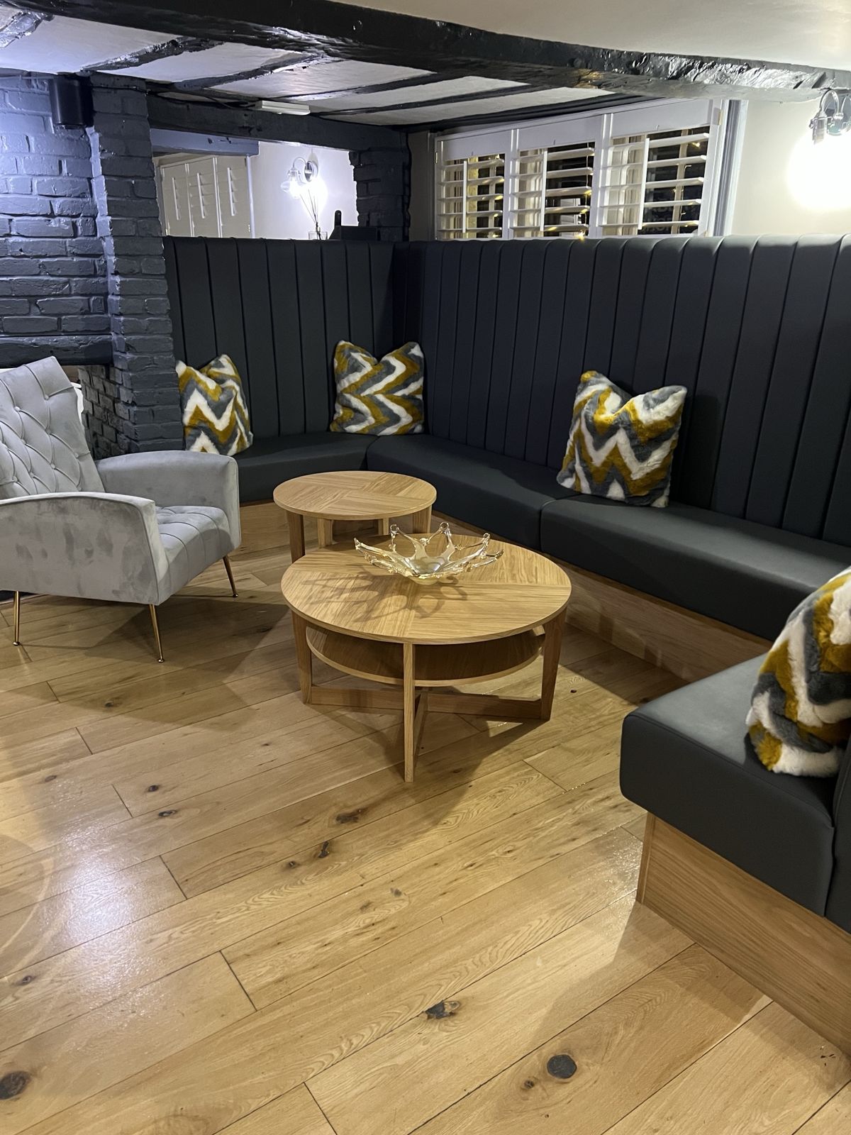 Snug with curved banquette seating, beams and oak floor